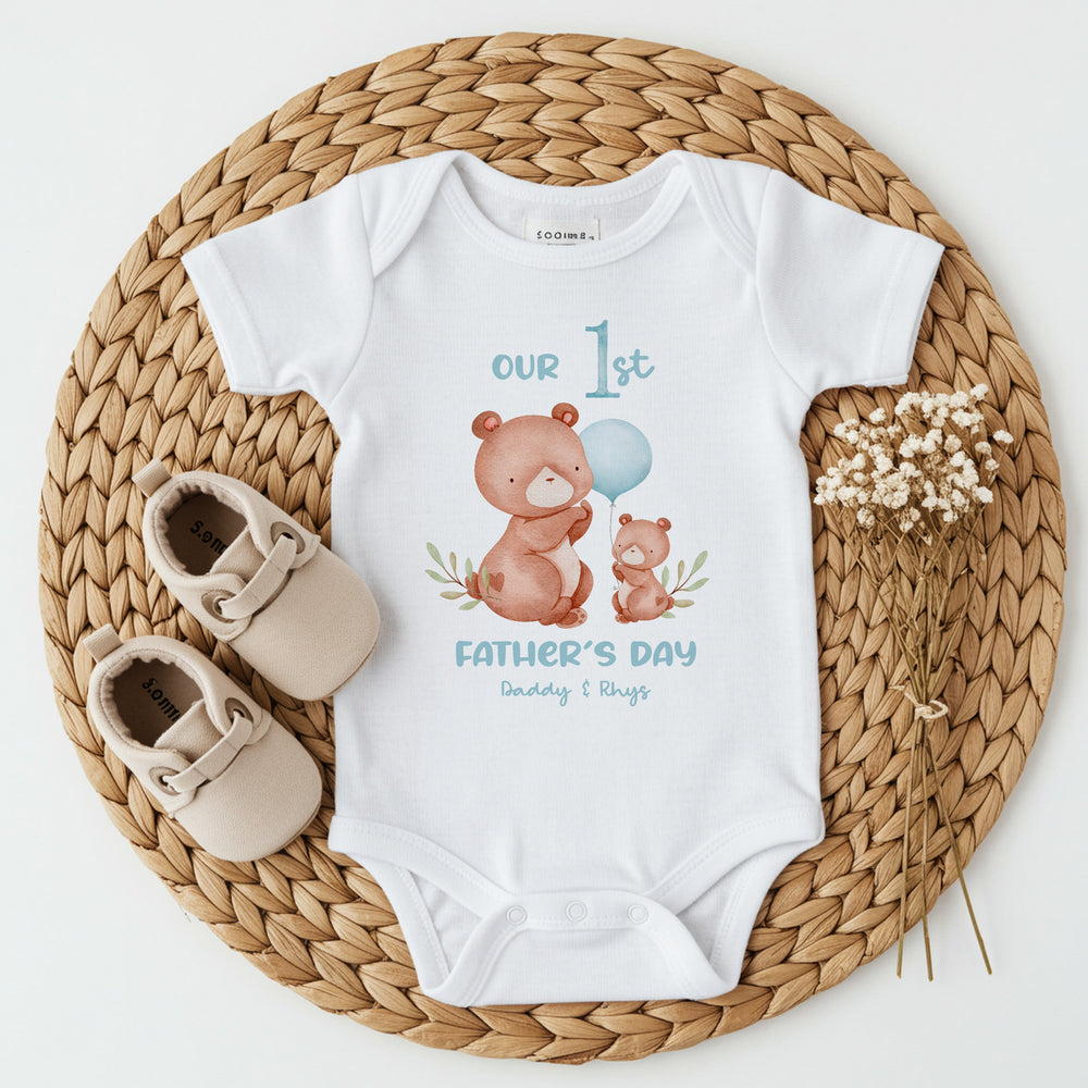 Personalised white Father's Day baby vest that says 'Our 1st Father's Day Daddy & Rhys'. This design features 2 brown bears and a blue balloon