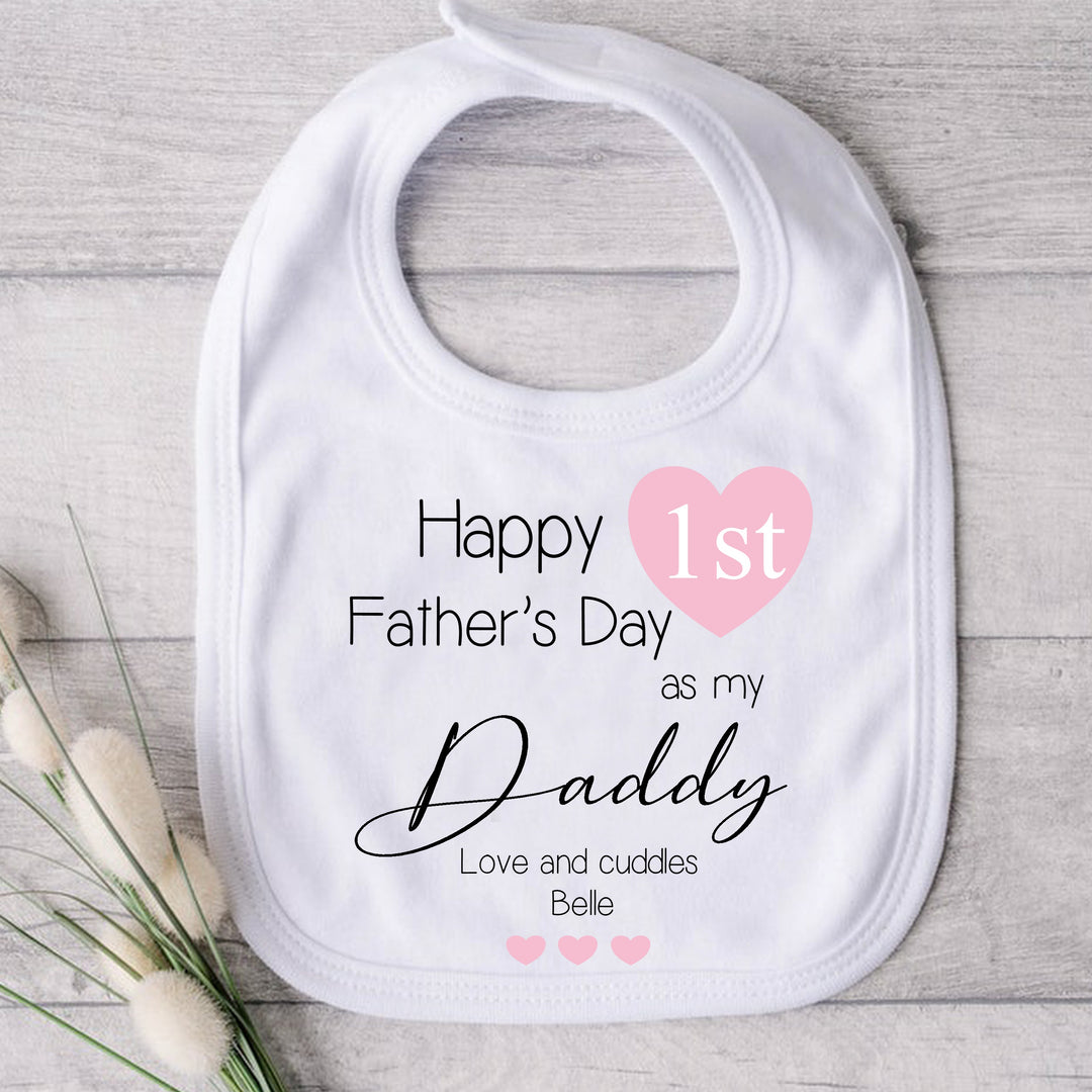 Personalised white Father's Day baby bib that says 'Happy 1st Father's Day as my Daddy Love and Cuddle Belle'. This design features a multiple pink hearts