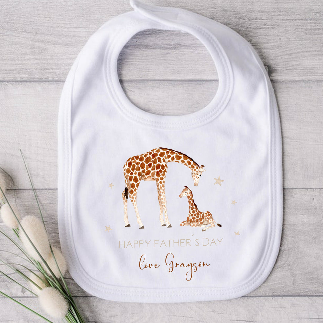 Personalised beige Father's Day baby bib that says 'Happy Father's Day Love Grayson'. This design features 2 giraffes surrounded by stars