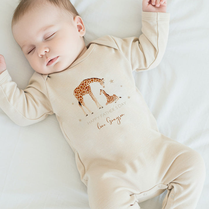 Personalised beige Father's Day baby grow/sleepsuit that says 'Happy Father's Day Love Grayson'. This design features 2 giraffes surrounded by stars