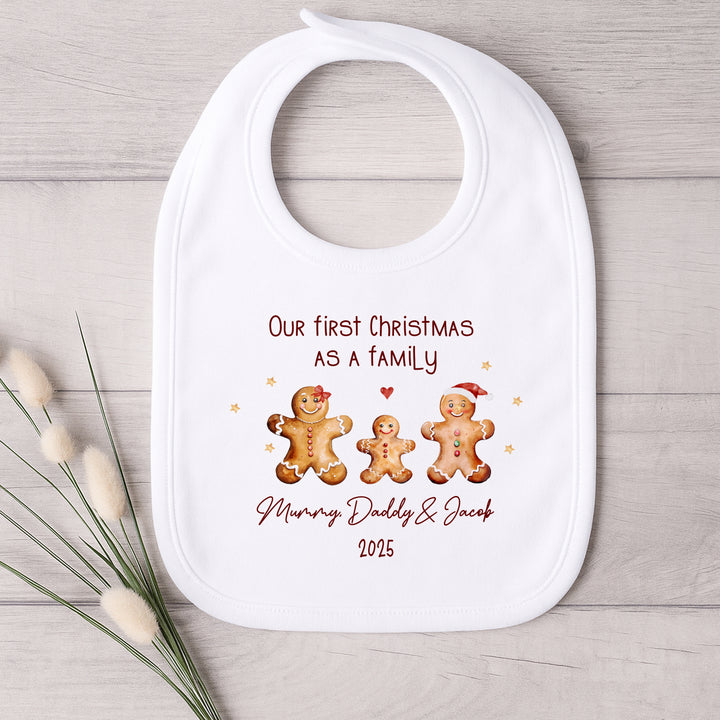 Baby bib with Christmas design and text on a wooden surface