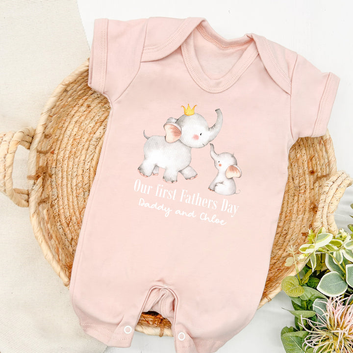 Personalised pink Father's Day baby romper that says 'Our First Fathers Day Daddy and Chloe'. This design features 2 elephants