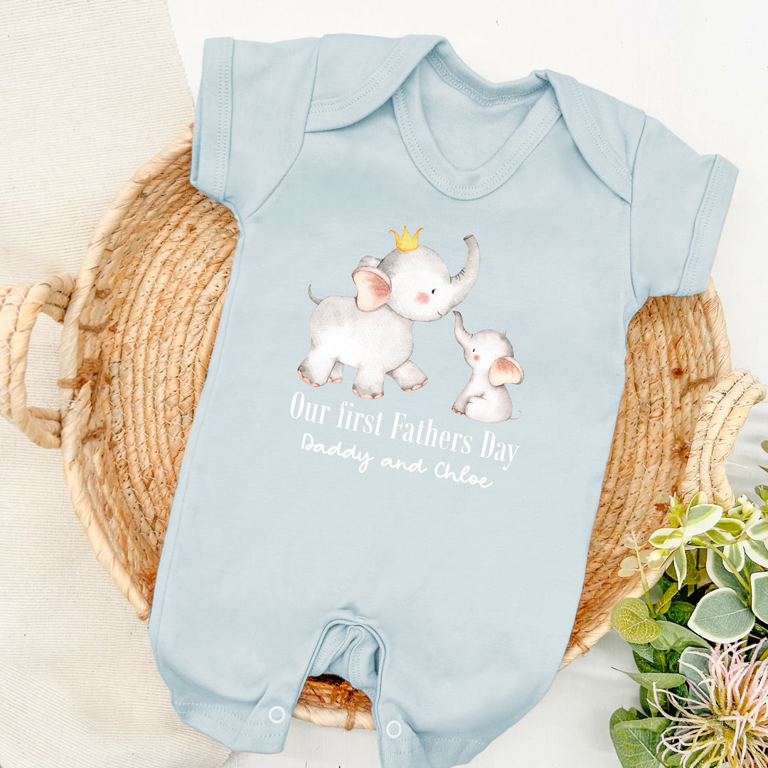 Personalised blue Father's Day baby romper that says 'Our First Fathers Day Daddy and Chloe'. This design features 2 elephants