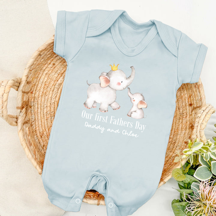 Personalised blue Father's Day baby romper that says 'Our First Fathers Day Daddy and Chloe'. This design features 2 elephants