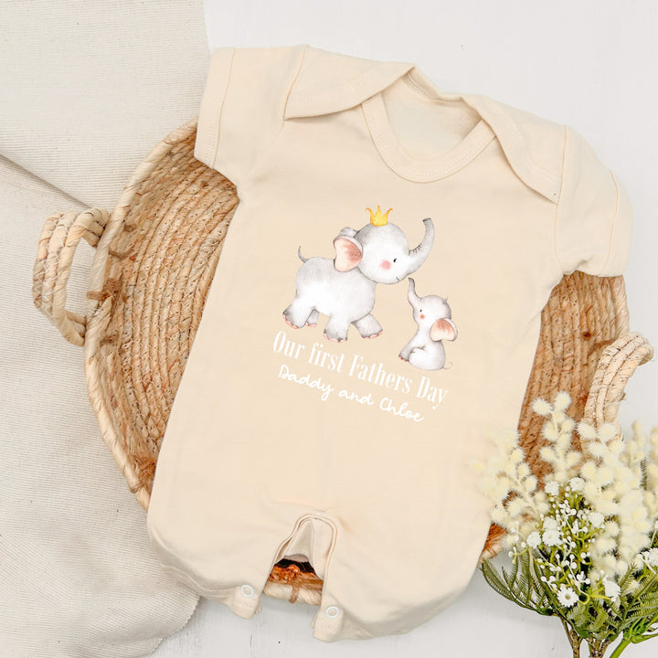 Personalised beige Father's Day baby romper that says 'Our First Fathers Day Daddy and Chloe'. This design features 2 elephants