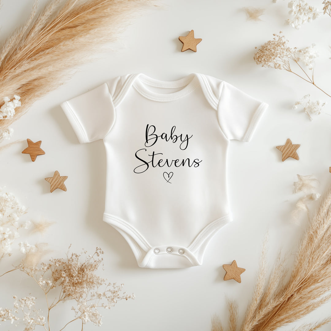 Baby announcement vests that says: Baby Stevens with a heart under