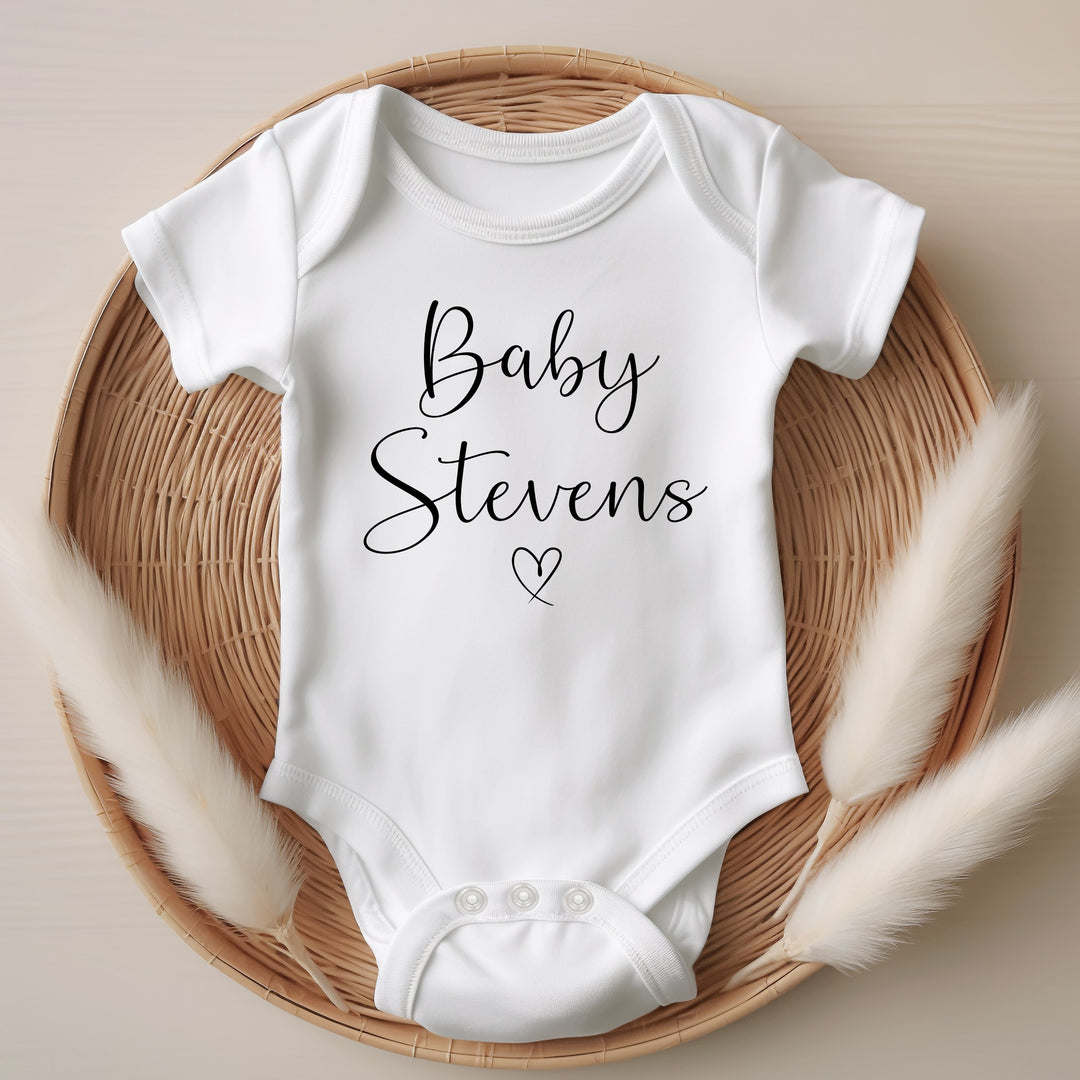 Baby announcement vests that says: Baby Stevens with a heart under