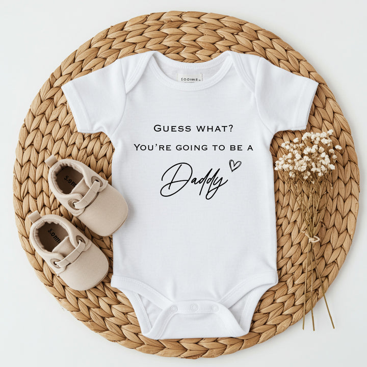 Baby announcement vests that says: 'Guess what? You're going to be a daddy' with heart 