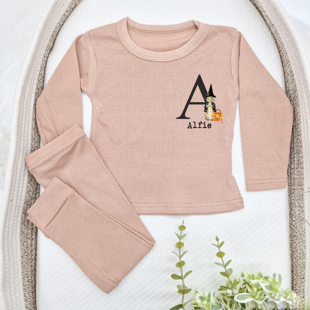 Pink children's outfit with a personalized design on a white background
