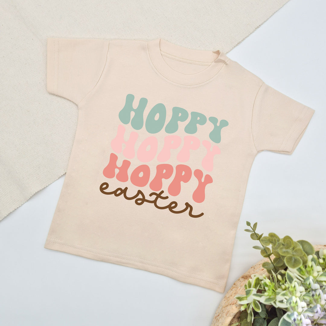 Oatmeal retro style Easter t-shirt that says 'Hoppy Easter'. This design features the word hoppy 3 times in 3 different colours stacked 