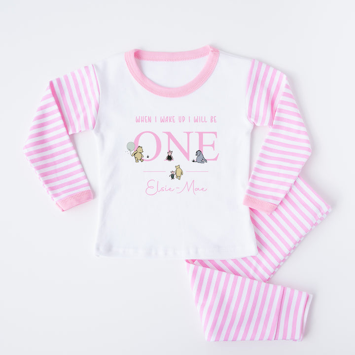 Personalised Pink stripe pyjamas that say 'When I wake up I will be ONE Elsie-Mae'. This design features the Classic Winnie the Pooh, Piglet and Eyore