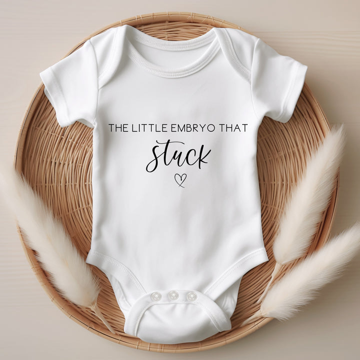 Baby announcement vests that says: The little embryo that stuck with a heart under