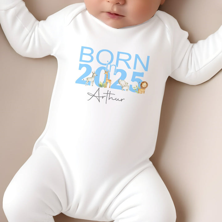 a personalised white baby grow that says 'Born in 2025 Arthur'. This design features safari animals