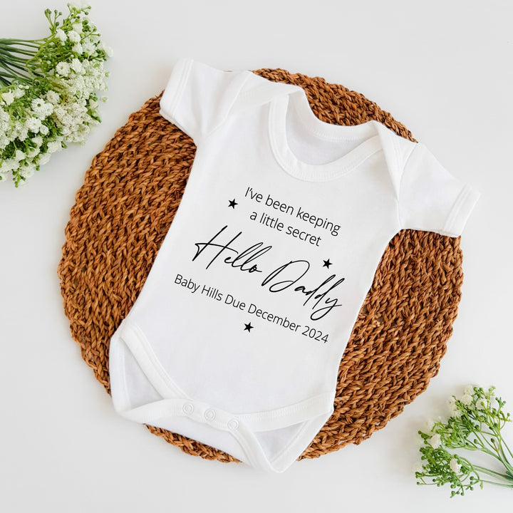 Baby announcement vests that says: I've been keeping a little secret Hello Daddy Baby Hills Due December 2024