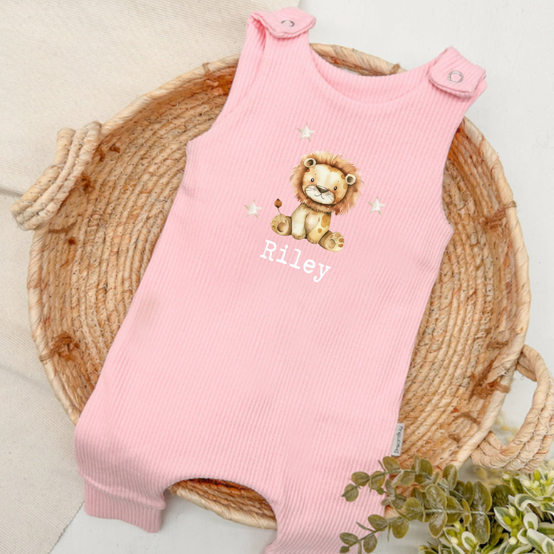 Personalised pink ribbed dungarees that say 'Riley'. This design features a lion surrounded by stars