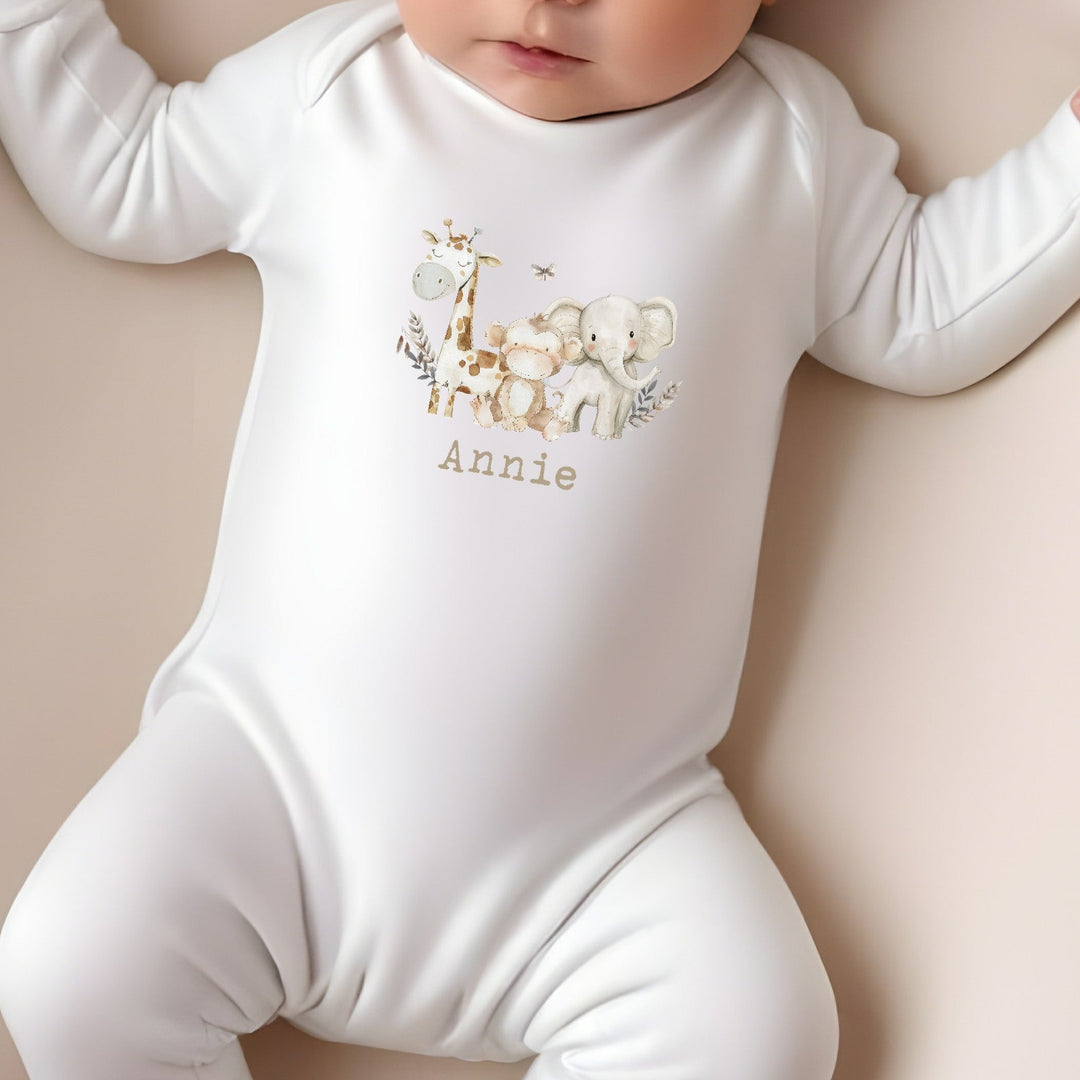 Personalised white baby grow that says 'Annie'. This design features 3 watercolour safari animals 