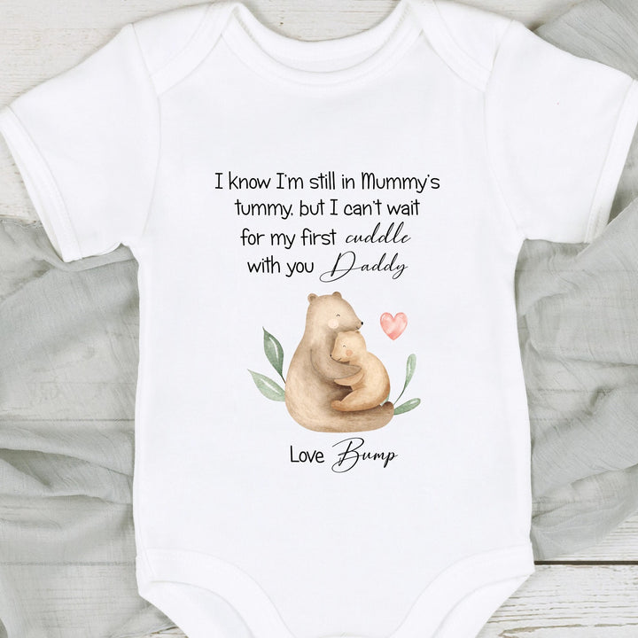 Baby announcement vests that says: ' I know I'm still in Mummy's tummy, but I can't wait for my first cuddle with you daddy. Love Bump' This vest has 2 bears cuddling on it 