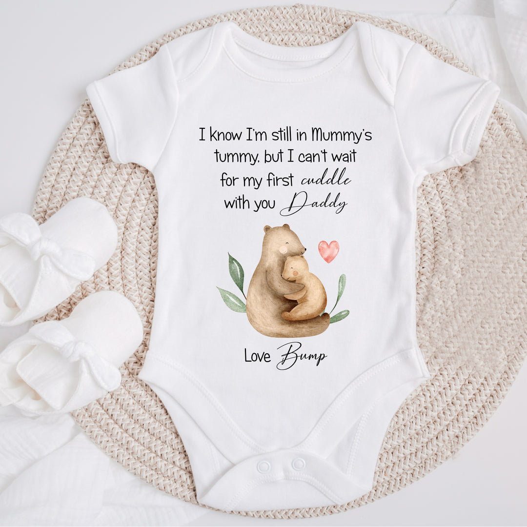 Baby announcement vests that says: ' I know I'm still in Mummy's tummy, but I can't wait for my first cuddle with you daddy. Love Bump' This vest has 2 bears cuddling on it 