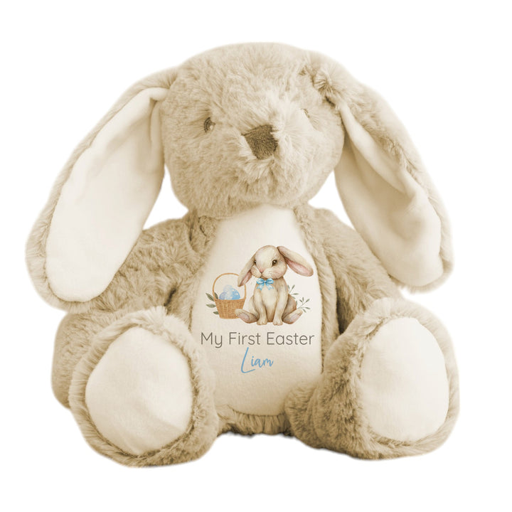 Personalised beige bunny Easter teddy that says 'My First Easter Liam'. This design features a brown bunny wearing a bow tie next to an Easter basket full of blue Easter eggs