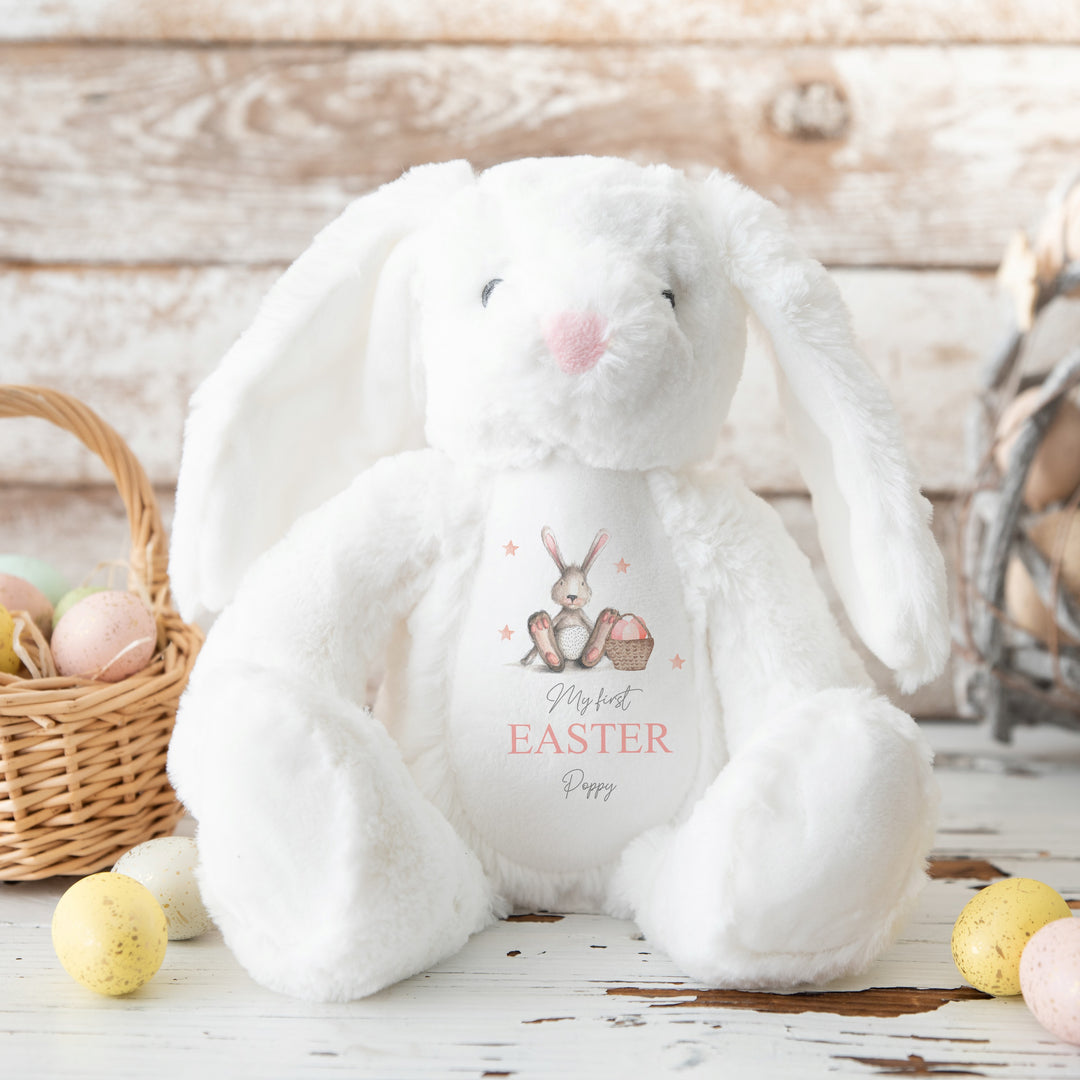 Personalised white bunny Easter teddy that says 'My First Easter Poppy'. This design features a grey bunny holding a a pink Easter basket