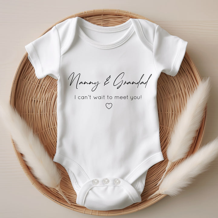 Baby announcement vests that says: Nanny & Grandad I can't wait to meet you! With a heart under