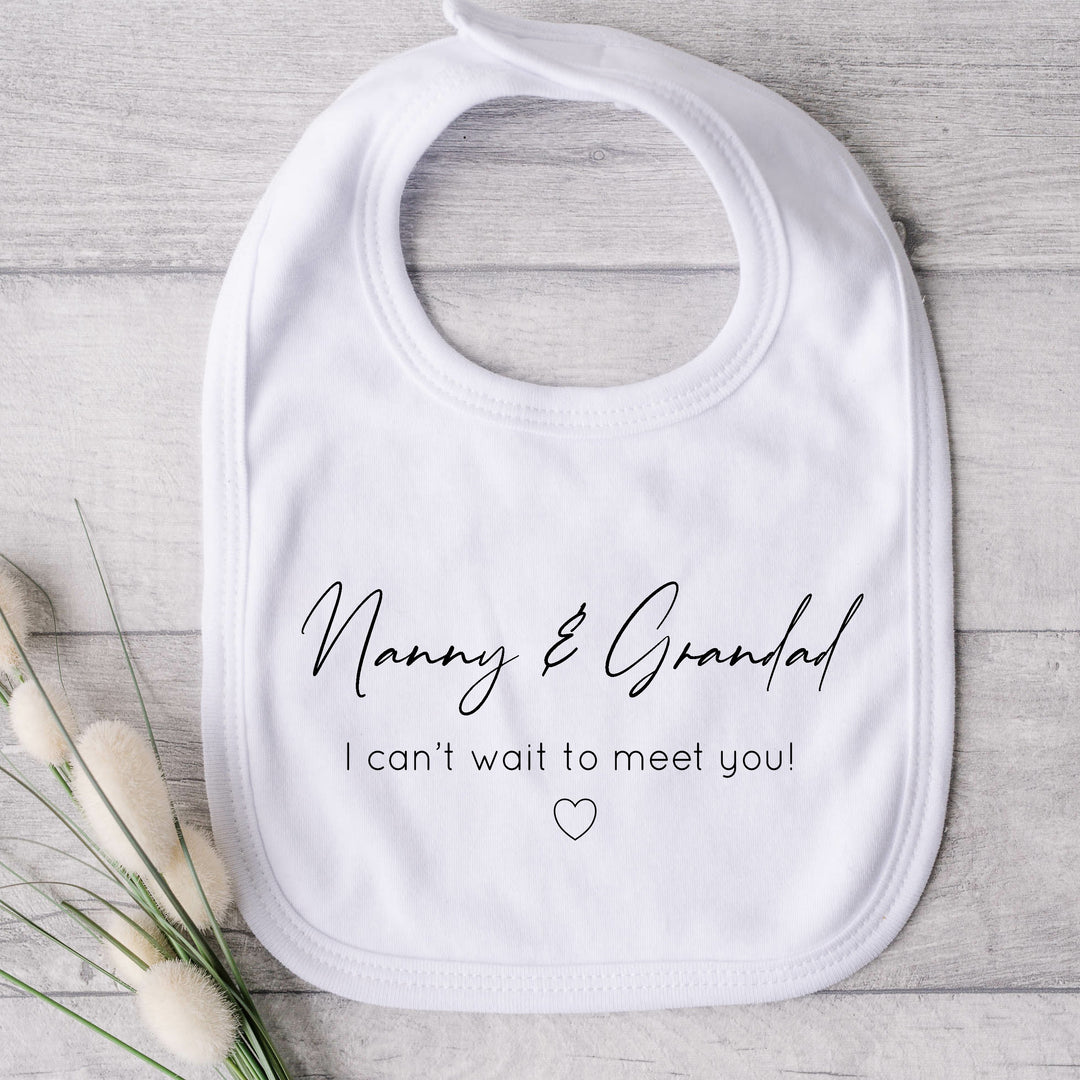 Baby bib that says: Nanny & Grandad I can't wait to meet you! With a heart under