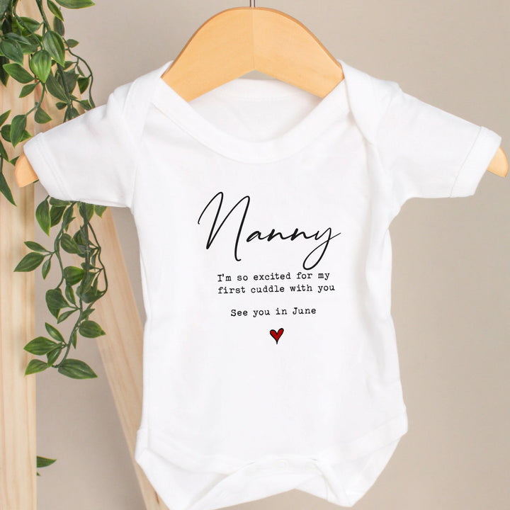 Baby announcement vests that says: Nanny I'm so excited for my first cuddle see you in June