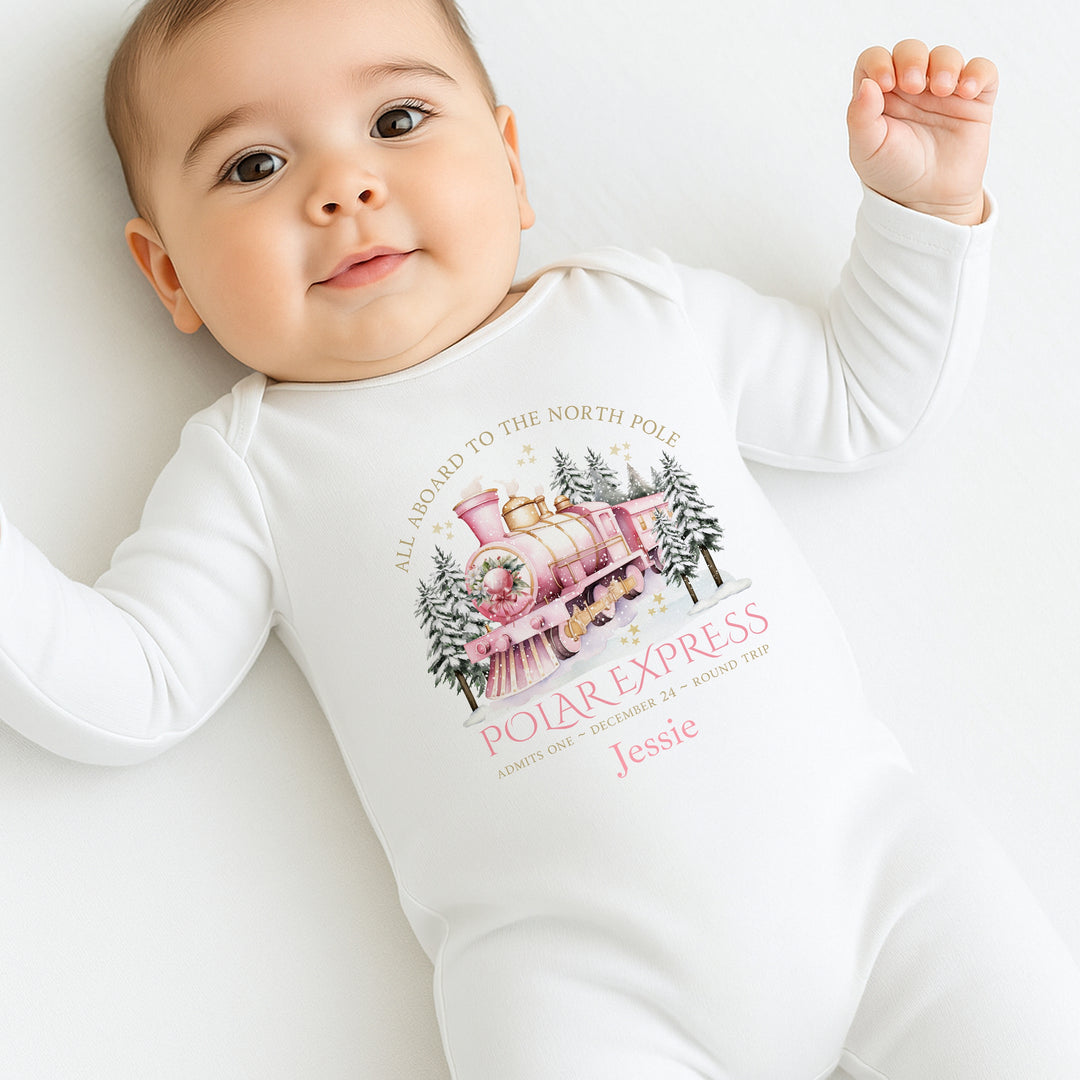 Baby wearing a 'Polar Express' themed onesie on a white background