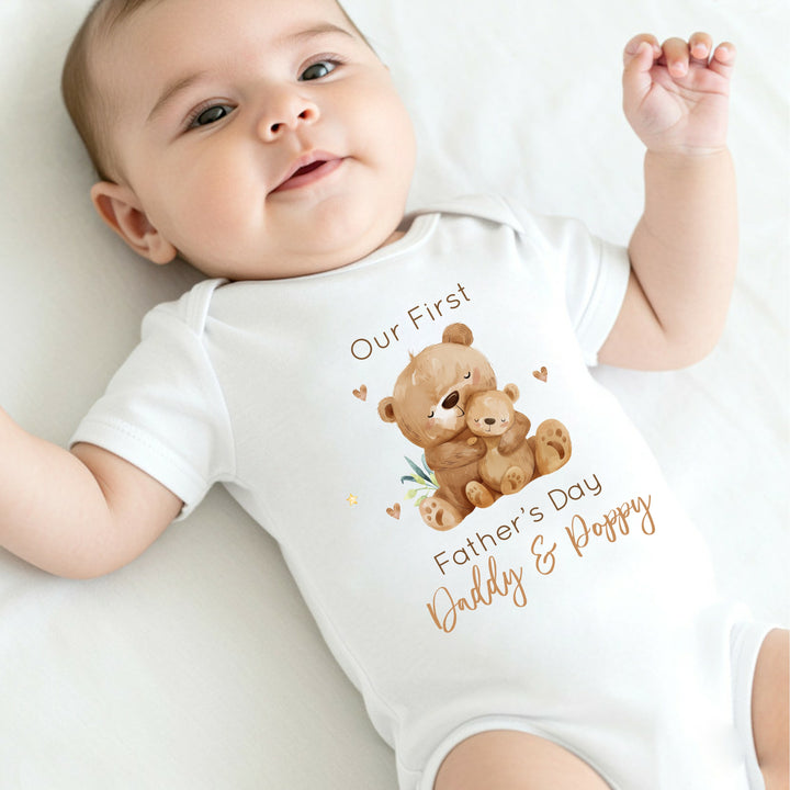 Personalised white Father's Day baby vest that says 'Our First Father's Day Daddy & Poppy'. This design features 2 brown bears