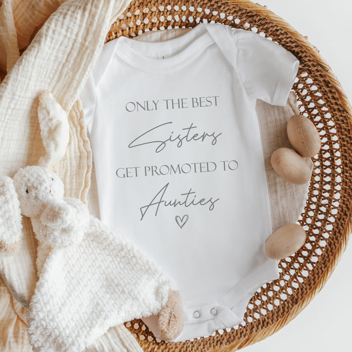 Baby announcement vests that says: 'Only the best sisters get promoted to Aunties' with a heart at the bottom