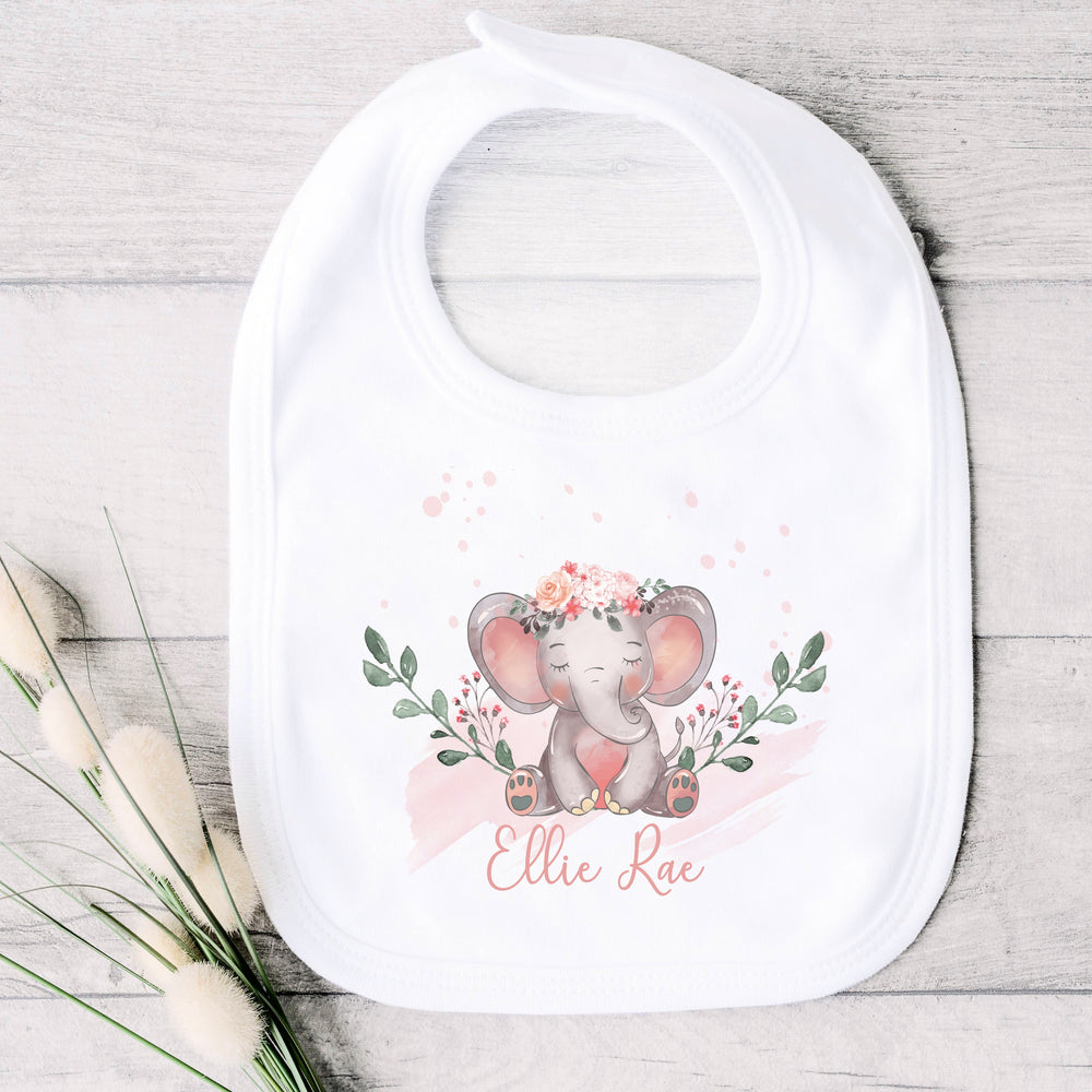 a personalised white baby bib that says 'Ellie Rae'. This design features an elephant wearing a flower crown