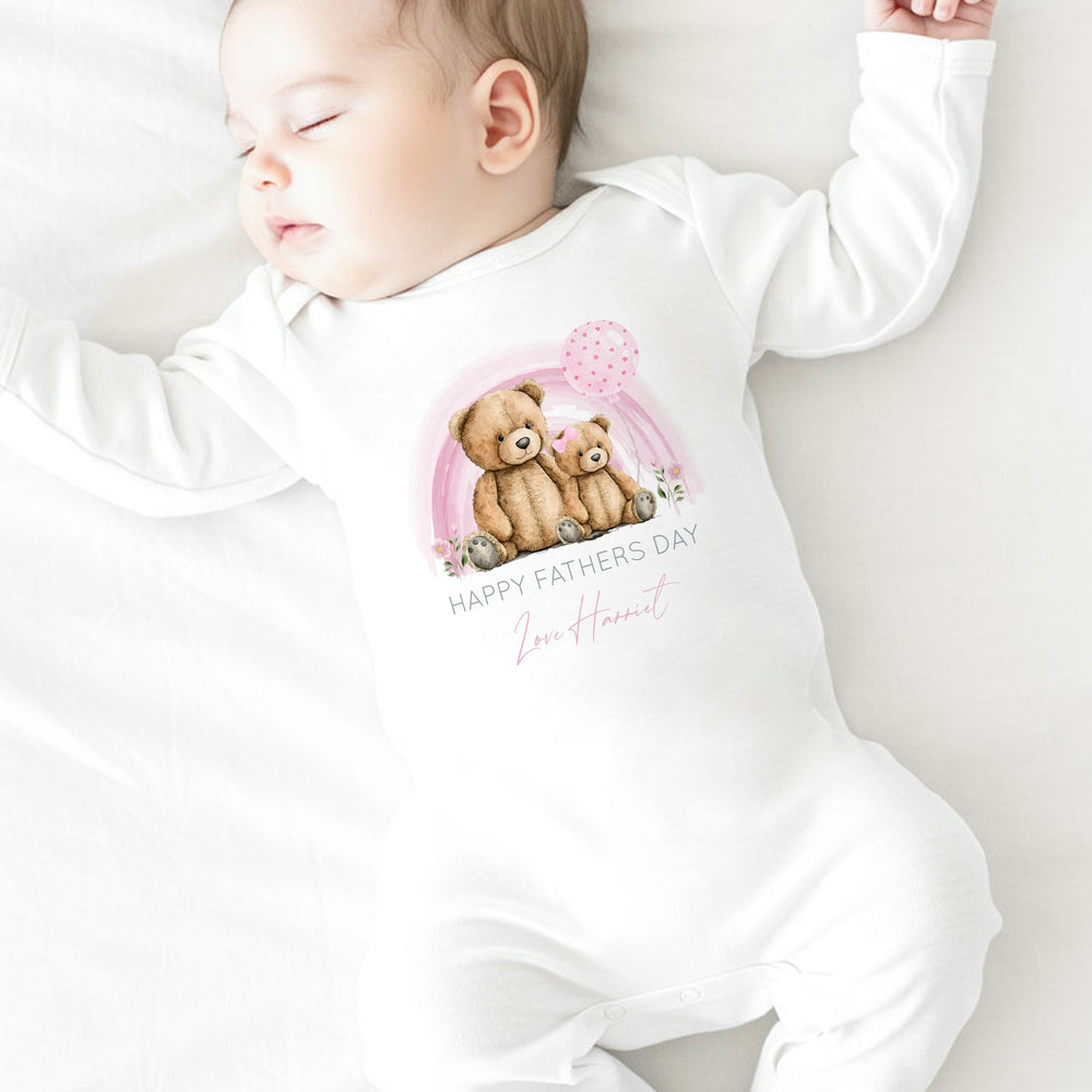 Personalised white Father's Day baby grow/sleepsuit that says 'Happy Fathers Day Love Harriet'. This design features a pink rainbow with 2 teddy bears sitting in the middle of it 