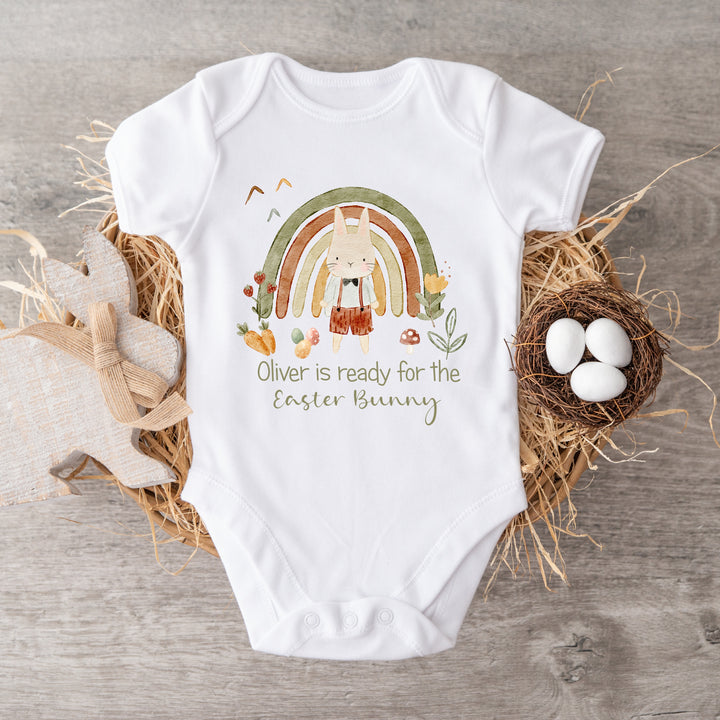 Personalised white Easter baby vest that says 'Oliver is ready for the Easter Bunny'. This design features a green rainbow with a rabbit standing in front of it