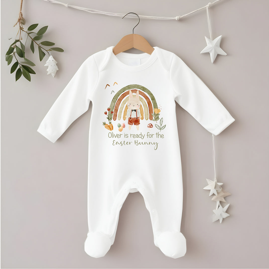 Personalised white Easter baby grow/sleepsuit that says 'Oliver is ready for the Easter Bunny'. This design features a green rainbow with a rabbit standing in front of it