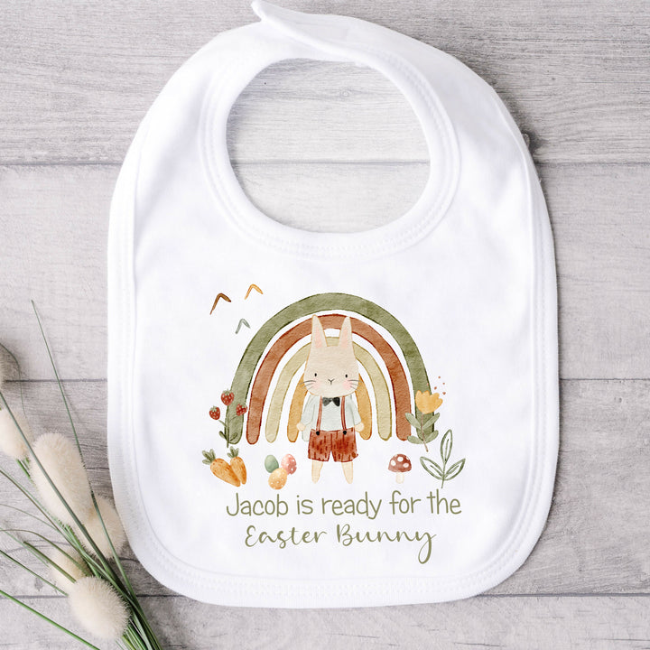 Personalised white Easter baby bib that says 'Jacob is ready for the Easter Bunny'. This design features a green rainbow with a rabbit standing in front of it