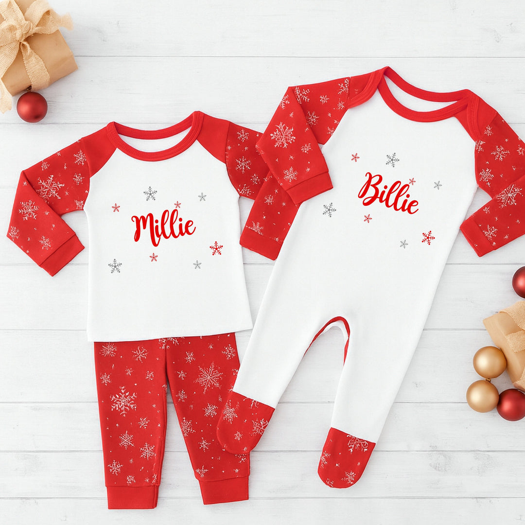Red and white pajamas with names on a wooden surface