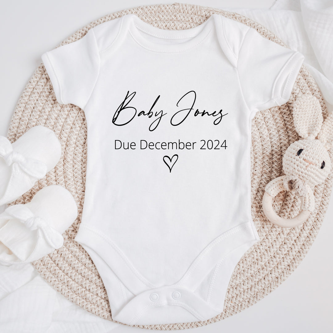 Baby announcement vests that says: Baby Jones Due December 2024 with a heart under