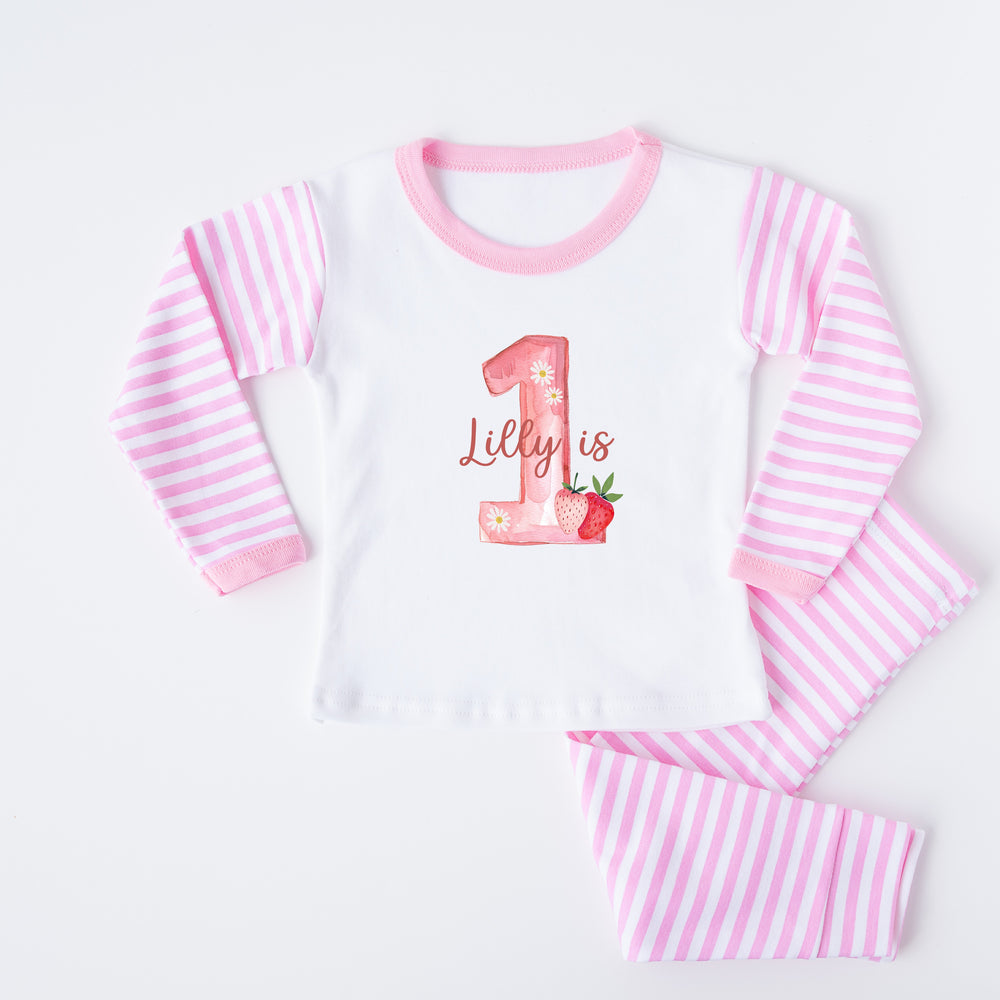 Personalised pink stripe birthday pyjamas saying 'Lilly is 1'. This design features a big pink 2 with strawberry and daisies surronding it