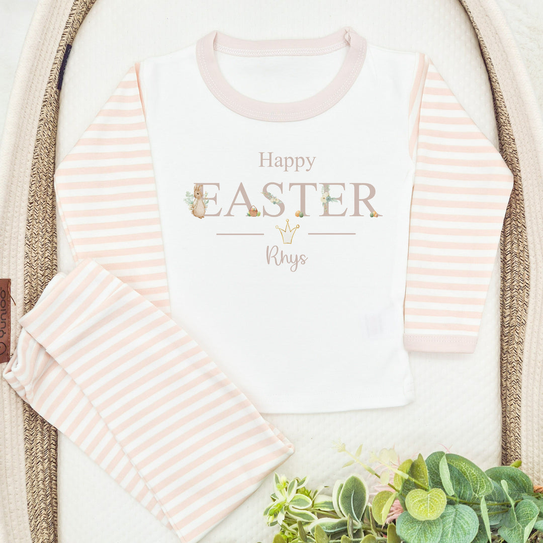 Personalised beige stripe Easter pyjamas that say 'Happy Easter Rhys'. This design features a rabbit wearing a beige jacket