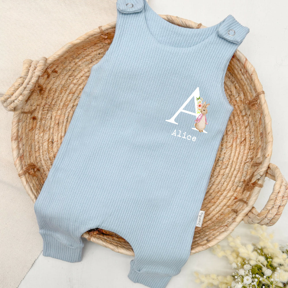 Personalised blue ribbed dungarees that say 'Alice'. This design features a rabbit wearing a pink jacket