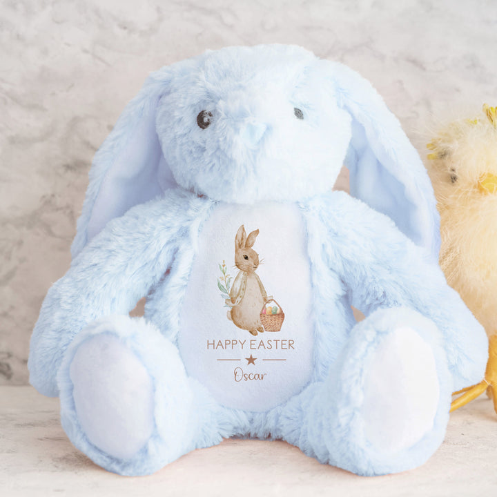 Personalised beige rabbit blue teddy that says 'Happy Easter Oscar'. This design features a rabbit wearing a beige jacket holding an Easter basket