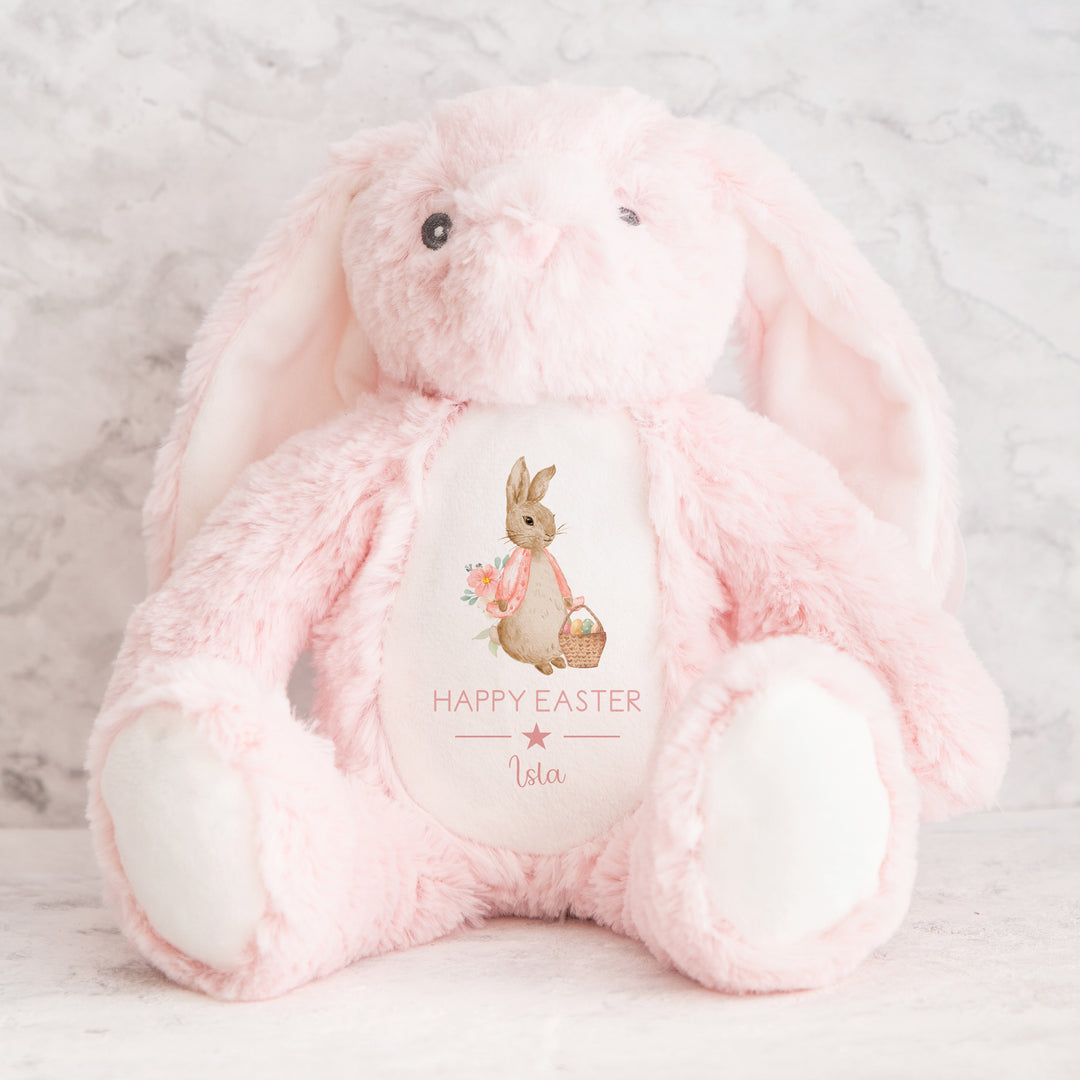 Personalised pink rabbit Easter teddy that says 'Happy Easter Isla'. This design features a rabbit wearing a pink jacket holing an Easter basket