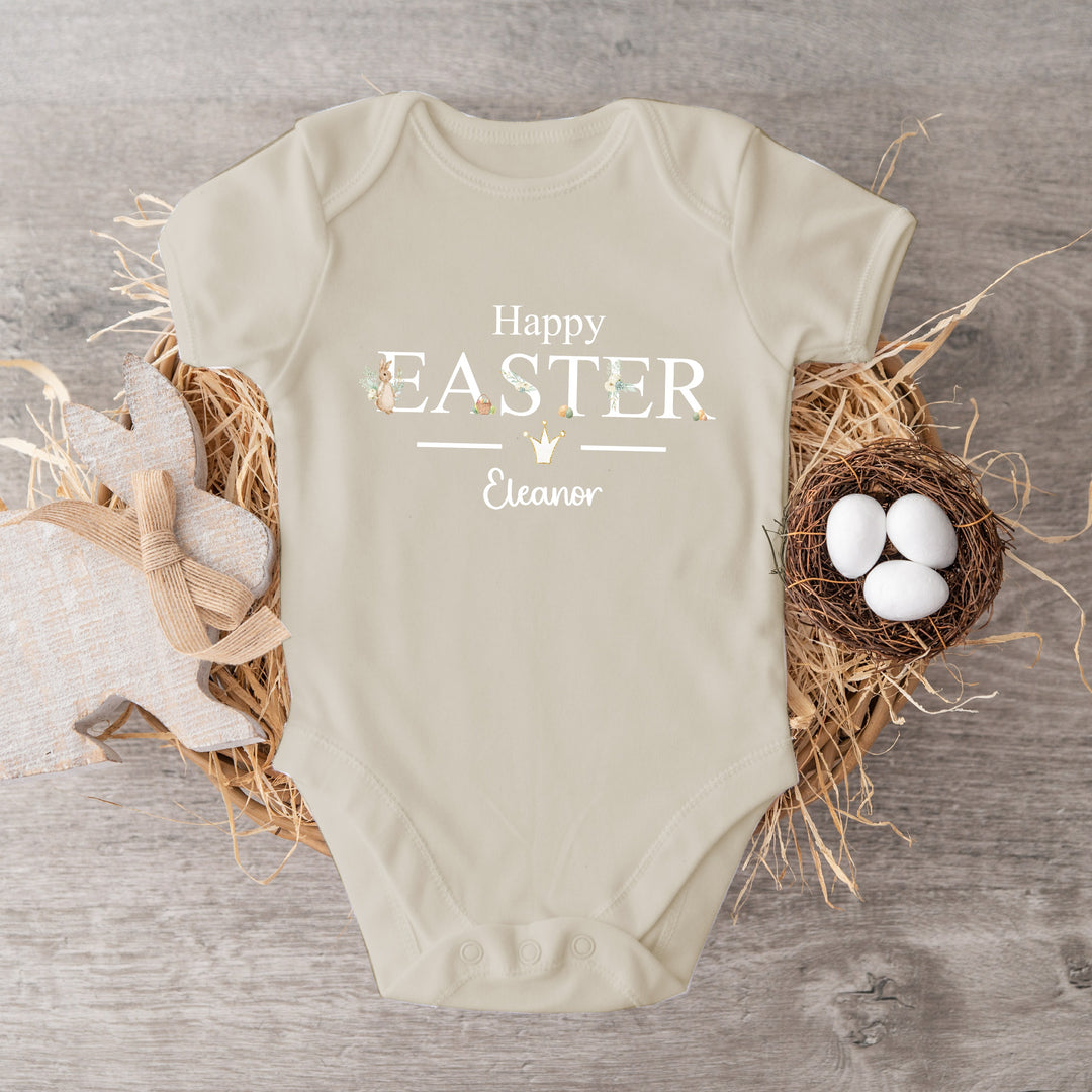 Personalised beige Easter baby vest that says 'Happy Easter Eleanor'. This design features a rabbit wearing a beige jacket