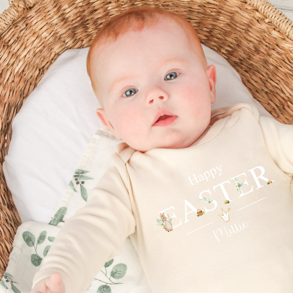 Personalised beige Easter baby grow/sleepsuit that says 'Happy Easter Millie'. This design features a rabbit wearing a beige jacket