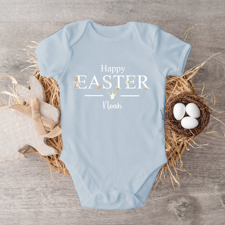 Personalised blue Easter baby vest that says 'Happy Easter Noah'. This design features a rabbit wearing a blue jacket with Easter eggs