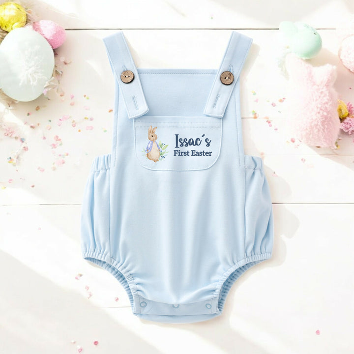 Personalised blue Easter dungarees that say 'Issac's First Easter'. This design features a rabbit wearing a blue jacket