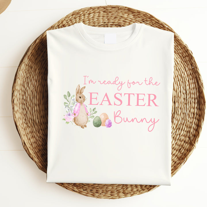 White childrens Easter t-shirt that says 'I'm ready for the Easter Bunny'. This design features a rabbit wearing a pink jacket standing next to some Easter eggs