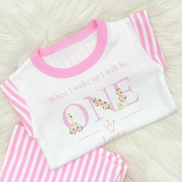 Personalised Pink stripe pyjamas that say 'When I wake up I will be ONE Layla'. This design features white swans and pink flowers