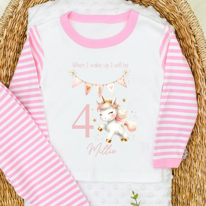 Personalised pink stripe birthday pyjamas that say 'When I wake up I will be 4 Millie'. This design features a pink pastel unicorn and pink bunting 