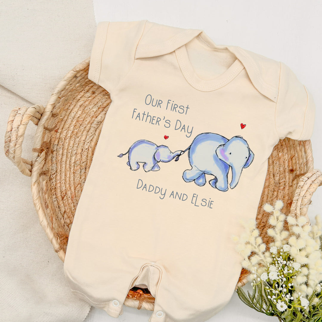 Personalised beige Father's Day romper that says 'Our first Father's Day Daddy and Elsie'. This design features 2 blue elephants